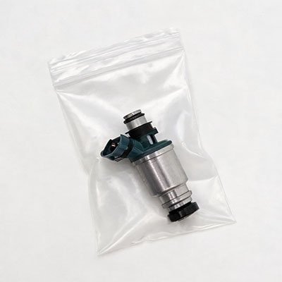 Fuel injector sealed in anti-static plastic bag for moisture and dust protection